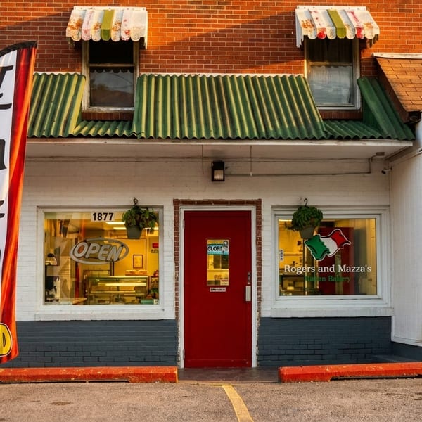 Rogers and Mazza's Italian Bakery storefront with a red door and an "Italian Food" banner.